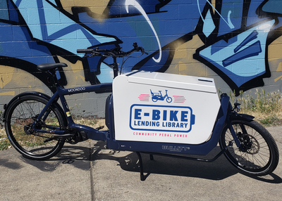 A bike with a large locking metal box on the front.